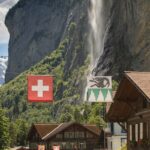 brown wooden house near waterfalls during daytime